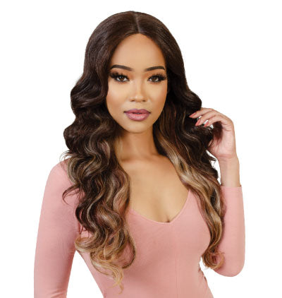 Woman with long, wavy hair in a pink top on a white background