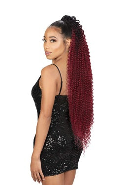 Woman with long, burgundy hair styled in a high ponytail wearing a black sequin dress.