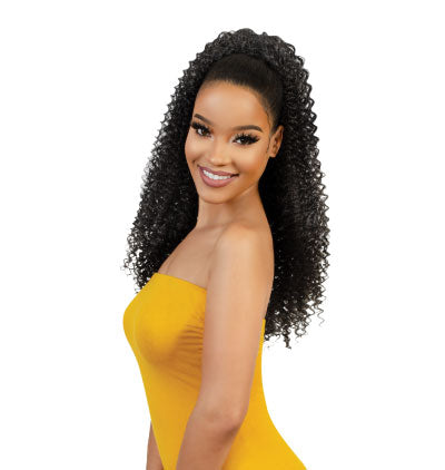Woman wearing a yellow halter dress and a long drawstring ponytail in curly texture.
