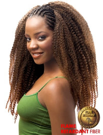 Woman with styled hair in braids wearing a green top on a white background, with a label for flame retardant fiber.