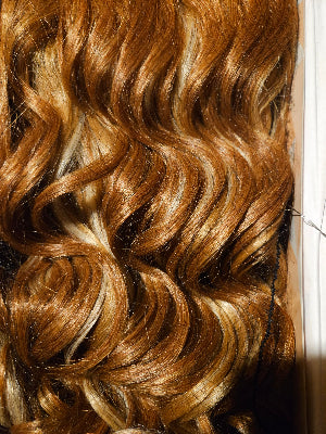 Close-up of carmel wig with a clear background