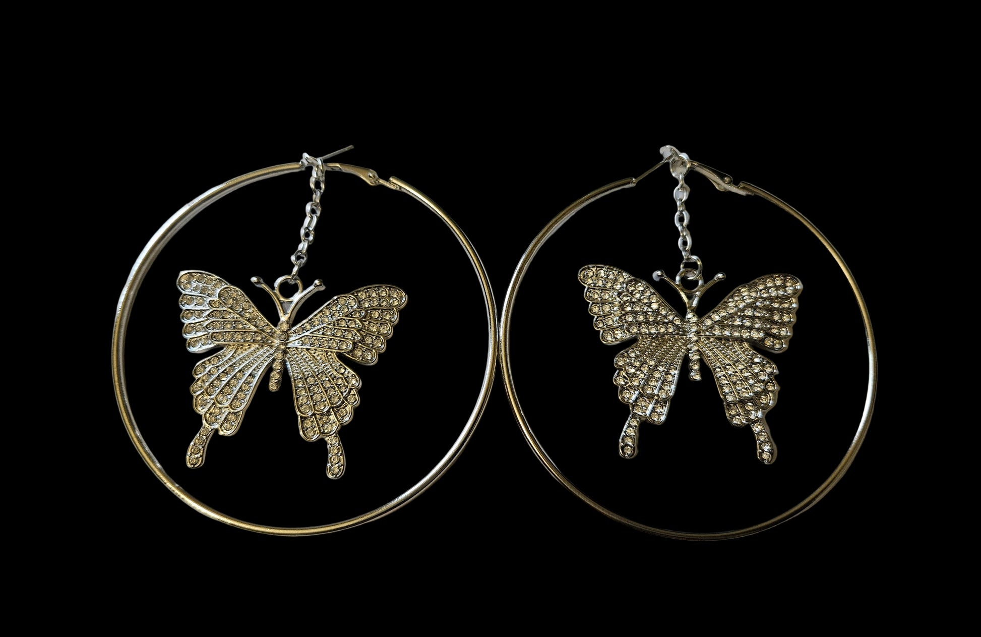 Hoop earrings in silvertone with rhinestone butterfly 